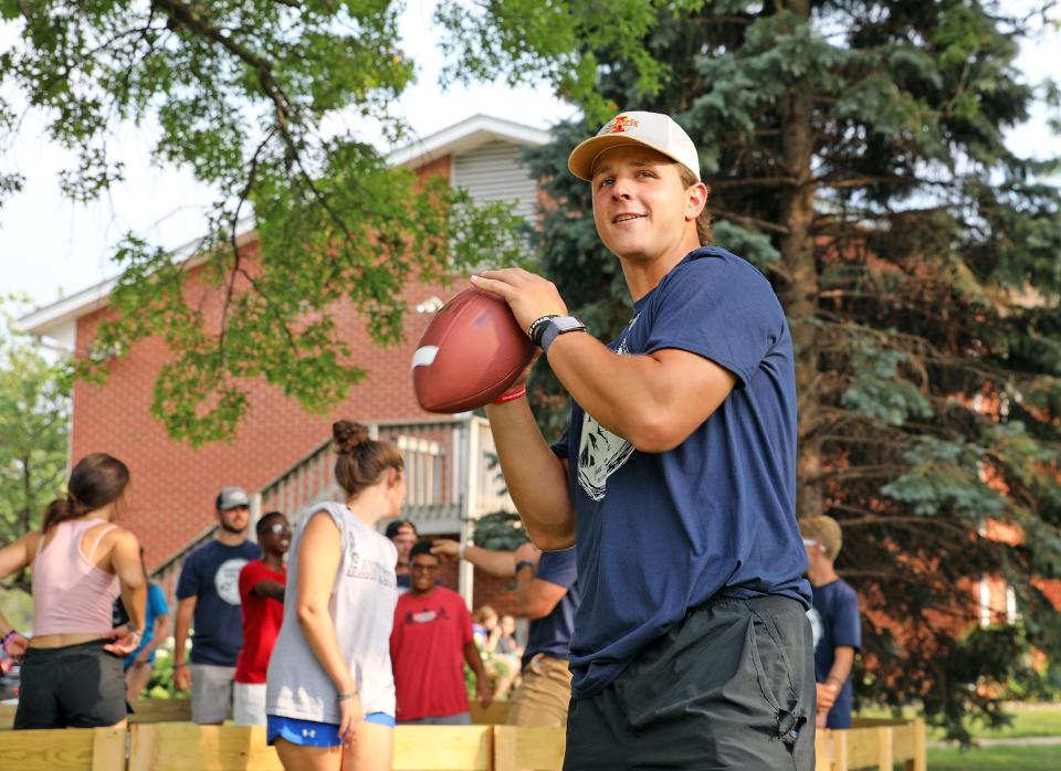 Iowa State University quarterback Brock Purdy throws passes to the kids who attended the first Empowered Youth event at The Well Covenant Church in Des Moines in 2021.