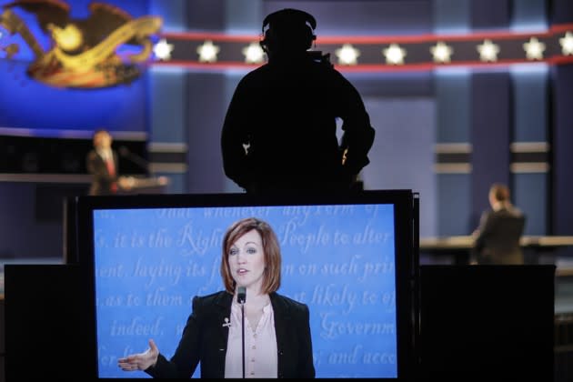 A student standing in for Hillary Clinton is captured on the large monitor during a rehearsal for the third presidential debate at the University of Nevada in Las Vegas. David Goldman / AP
