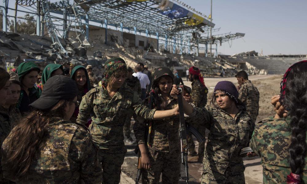 Members of the Syrian Democratic Forces celebrate at a stadium that was the site of Islamic State fighters’ last stand in the city of Raqqa.