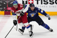 Finland's Mikael Granlund, right, challenges Czech Republic's Ondrej Kase during the preliminary round match between Czech Republic and Finland at the Ice Hockey World Championships in Prague, Czech Republic, Friday, May 10, 2024. (AP Photo/Petr David Josek)