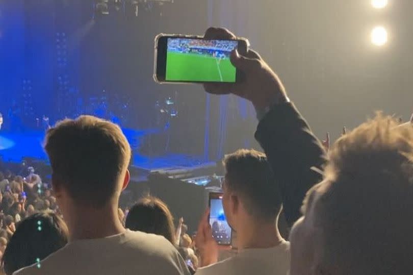 Some fans at the Kings of Leon concert seemed more interested in the football result
