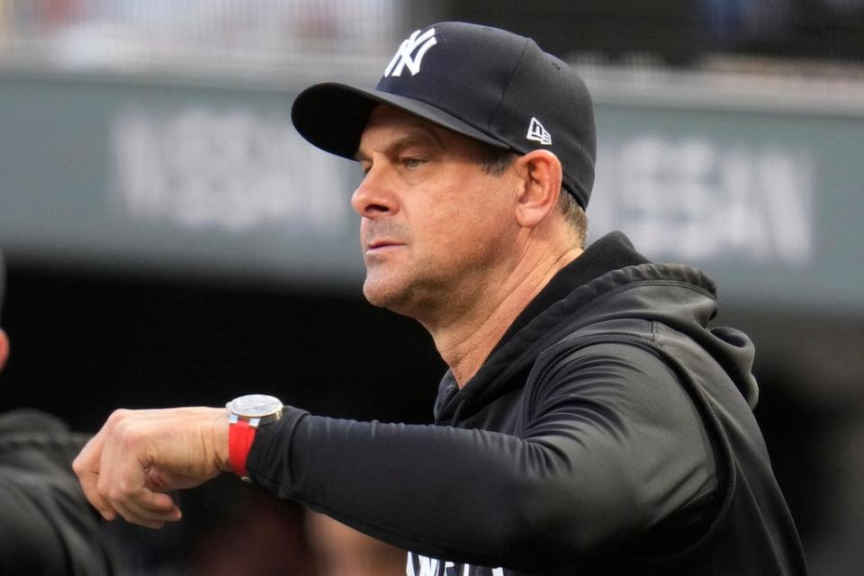 New York Yankees manager Aaron Boone stands on the dugout steps during the first inning of the team's baseball game against the Pittsburgh Pirates in Pittsburgh, Saturday, Sept. 16, 2023. (AP Photo/Gene J. Puskar)