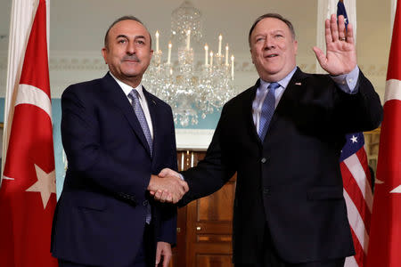 U.S. Secretary of State Mike Pompeo (R) shakes hands with Turkey's Foreign Minister Mevlut Cavusoglu before their meeting at the State Department in Washington, U.S., November 20, 2018. REUTERS/Yuri Gripas