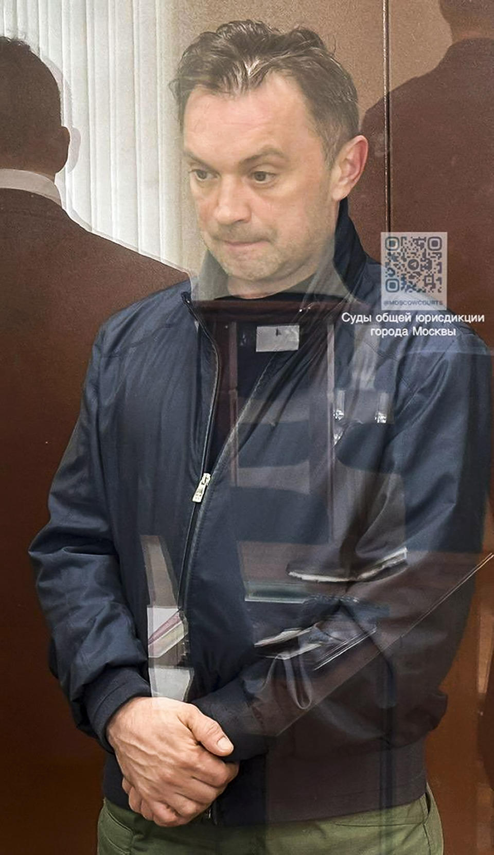 This photo taken and released by Basmanny District Court press service on Thursday, April 25, 2024, shows businessman Alexander Fomin standing in a glass cage in the Basmanny District Court in Moscow, Russia. Moscow's court service says a third man has been detained in a major bribery case involving a Russian deputy defense minister. It says businessman Alexander Fomin is suspected of paying bribes to Deputy Defense Minister Timur Ivanov as well as Ivanov's associate, (Basmanny District Court press service via AP)