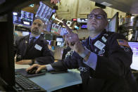 FILE - In this Tuesday, March 10, 2020, file photo, specialists James Denaro, left, and Mario Picone work on the floor of the New York Stock Exchange. Global stock markets and Wall Street futures rose Thursday, July 2, 2020, on hopes for the development of a coronavirus vaccine and ahead of the release of monthly U.S. jobs data. (AP Photo/Richard Drew, File)