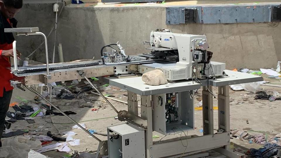 After realizing that this specialized sewing machine was too heavy to carry, looters of the Pravi Apparel factory in Gonaives left it behind and destroyed it. Courtesy of Jim Weber