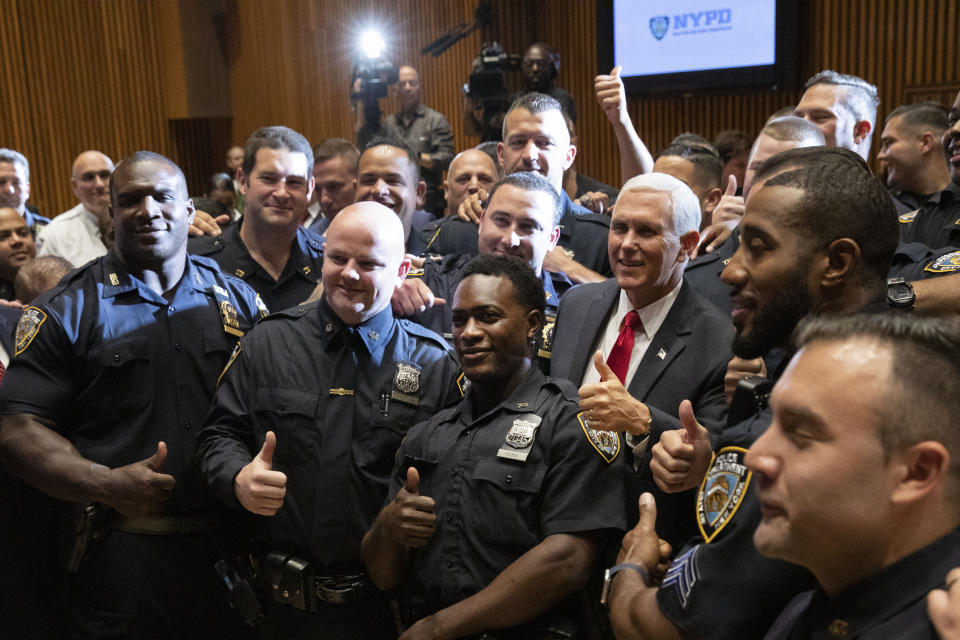 Vice President Mike Pence, second from right, meets with members of the New York Police Department's football team, Thursday, Sept. 19, 2019. Pence met earlier with the NYPD for a counterterrorism briefing. (AP Photo/Mark Lennihan)