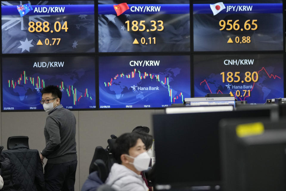 A currency trader passes by the screens showing the foreign exchange rates at the foreign exchange dealing room of the KEB Hana Bank headquarters in Seoul, South Korea, Wednesday, Nov. 30, 2022. Asian shares were mostly lower Wednesday ahead of a closely watched speech by the Federal Reserve chief that may give clues about future interest rate hikes. (AP Photo/Ahn Young-joon)