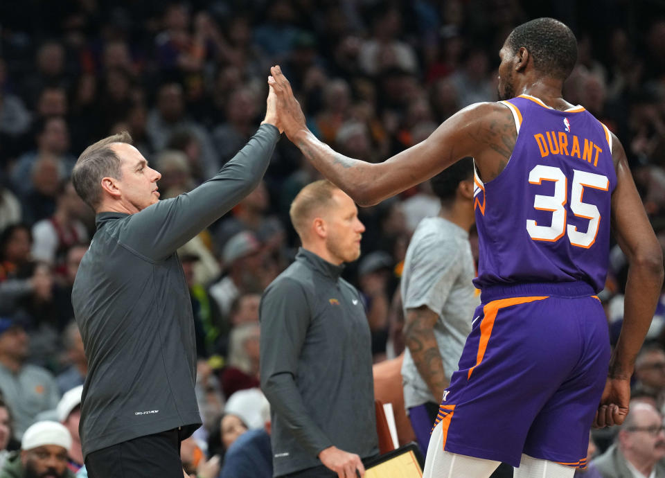 Phoenix Suns head coach Frank Vogel and Phoenix Suns forward Kevin Durant (35) slap hands during the first half of the game against the Toronto Raptors at Footprint Center.