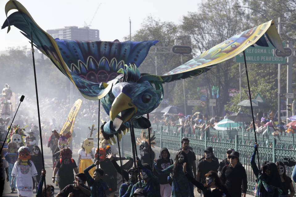 Participants take part in a James Bond-inspired Day of the Dead Parade, in Mexico City, Saturday, Nov. 4, 2023. The Hollywood-style parade was adopted in 2016 by Mexico City to mimic a fictitious march in the 2015 James Bond movie “Spectre.” (AP Photo/Ginnette Riquelme)