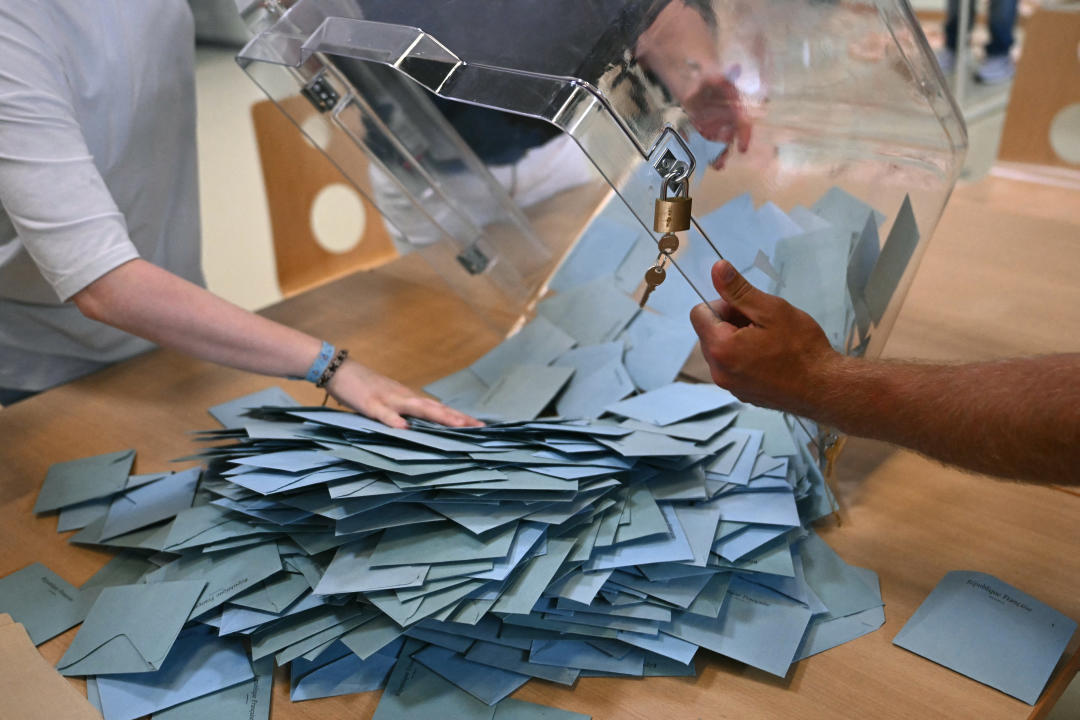 Election officials empty a ballot box to count votes during the second round of France's legislative election at a polling station in Illkirch-Graffenstaden, eastern France on July 7, 2024. France votes in legislative elections on July 7, 2024 that will be decisive in determining its political future and could see the far right become the largest party in parliament for the first time. (Photo by SEBASTIEN BOZON / AFP) (Photo by SEBASTIEN BOZON/AFP via Getty Images)