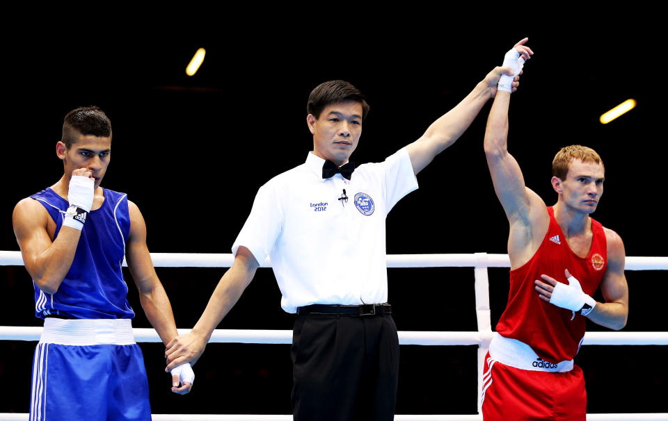 LONDON, ENGLAND - JULY 28: Sergey Vodopiyanov of Russia (R) celebrates his victory over Alberto Ezequiel Melian of Argentina during their Men's Bantam Weight (56kg) bout on Day 1 of the London 2012 Olympic Games at ExCeL on July 28, 2012 in London, England. (Photo by Scott Heavey/Getty Images)