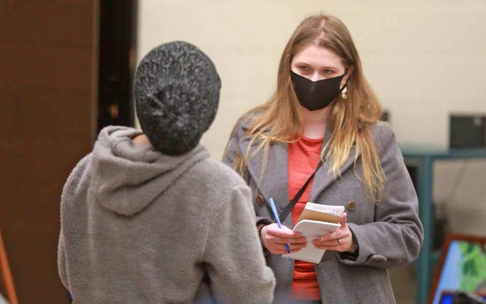 Columbus Dispatch reporter Danae King interviews a woman about a program to aid immigrants.