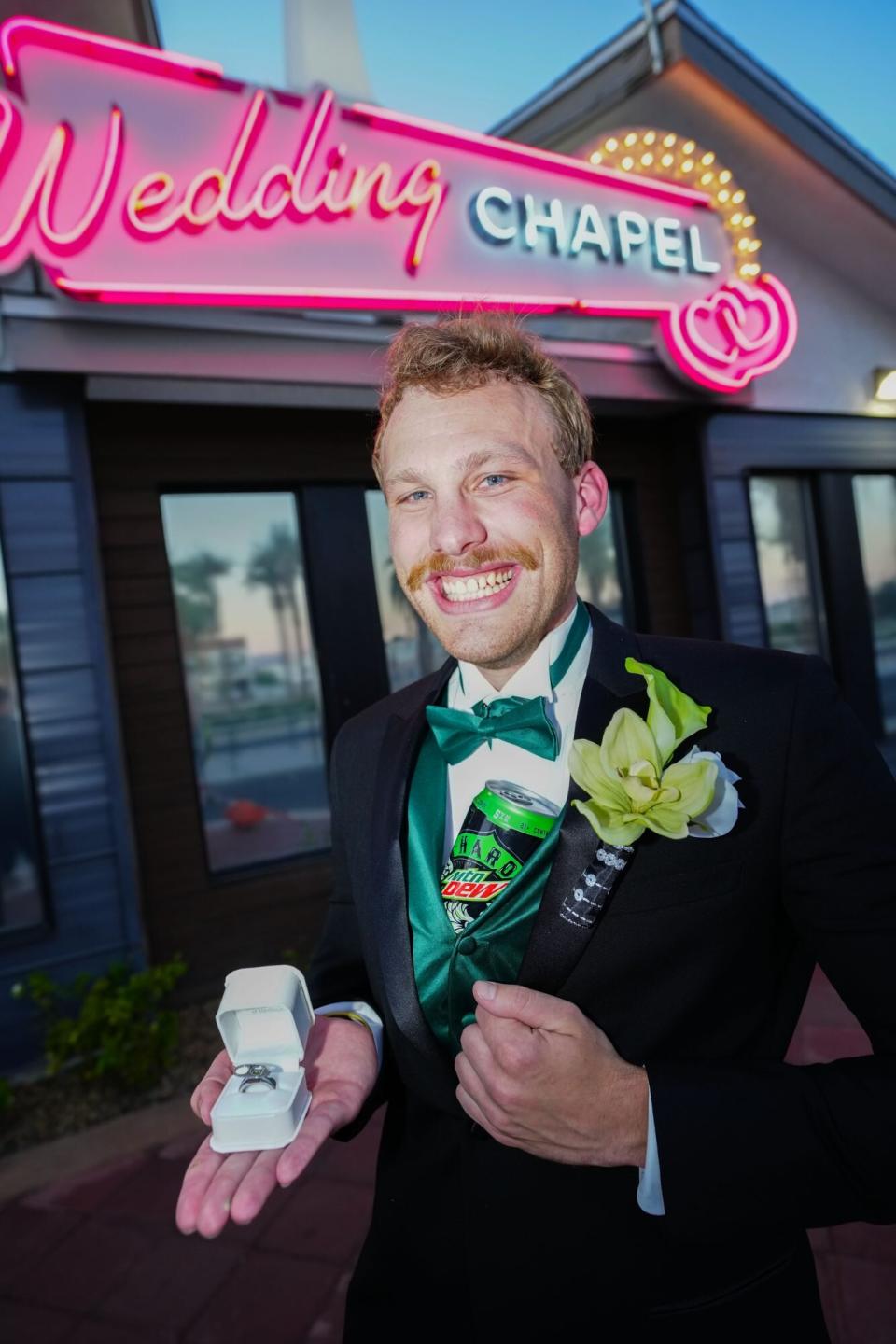 Thomas Rank poses with a ring in front of a Las Vegas wedding chapel