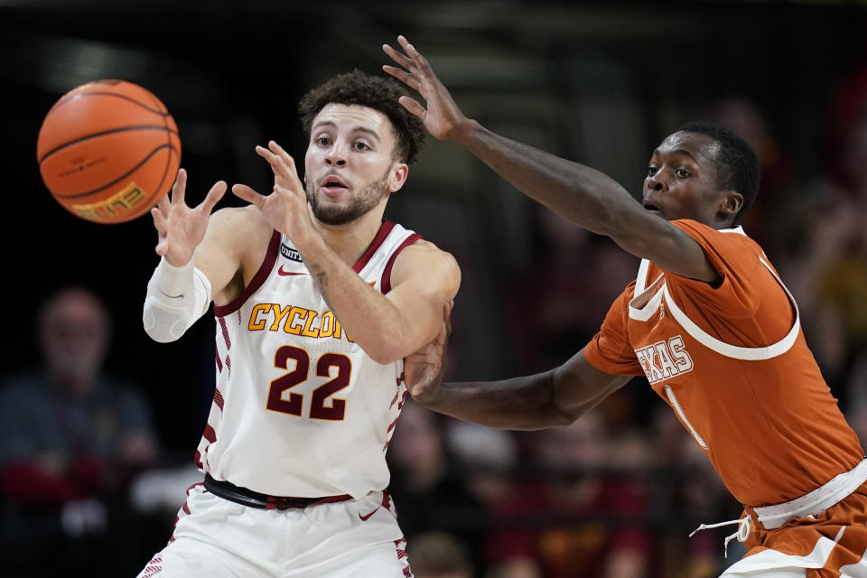 Texas guard Andrew Jones, right, tries to steal the ball from Iowa State guard Gabe Kalscheur (22) during the second half of an NCAA college basketball game, Saturday, Jan. 15, 2022, in Ames, Iowa. (AP Photo/Charlie Neibergall)
