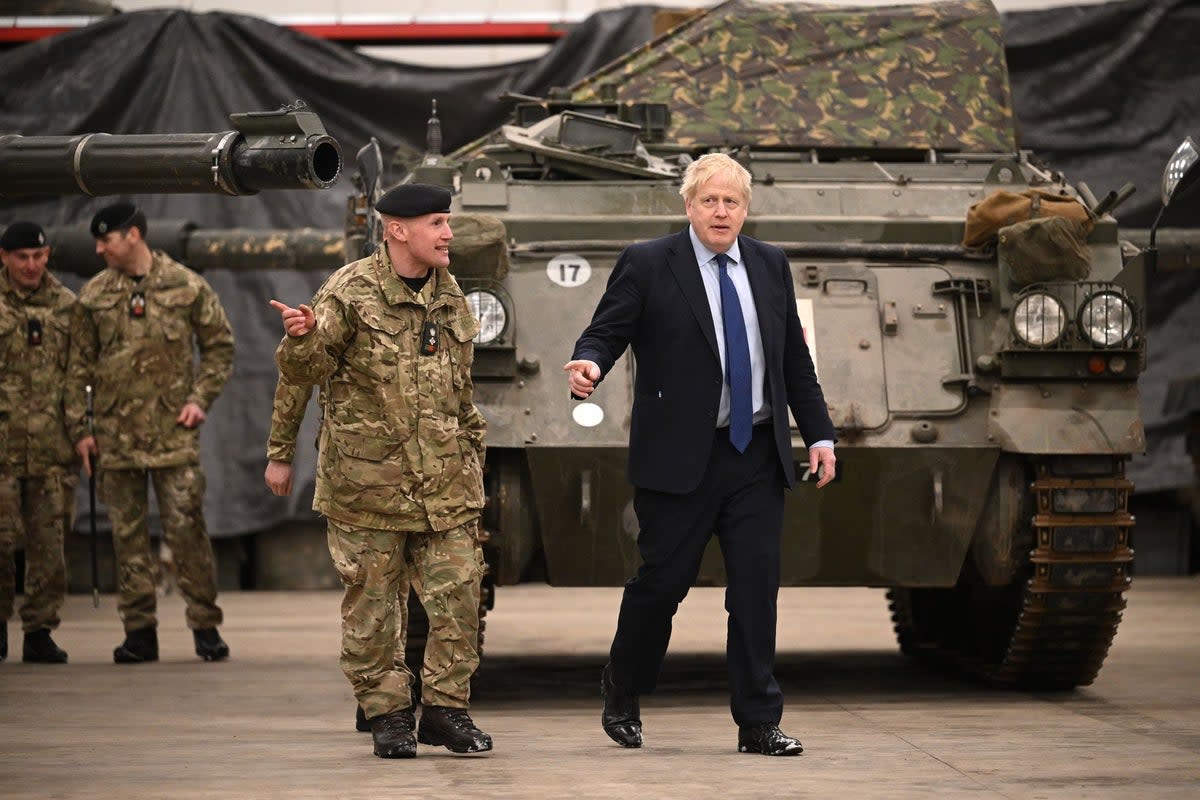 Johnson is shown around the Royal Tank Regiment Battlegroup by Lt Colonel Simon Worth (PA)