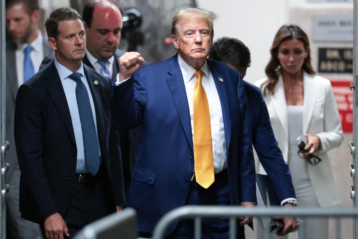 Former President Donald Trump gestures to the press as he returns to the courtroom after a break in his trial for allegedly covering up hush money payments linked to extramarital affairs, at Manhattan Criminal Court in New York City, on May 7, 2024.