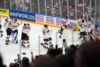 Latvia celebrates their game winning goal in overtime over the United States in their bronze medal match at the Ice Hockey World Championship in Tampere, Finland, Sunday, May 28, 2023. Latvia won 4-3. (AP Photo/Pavel Golovkin)