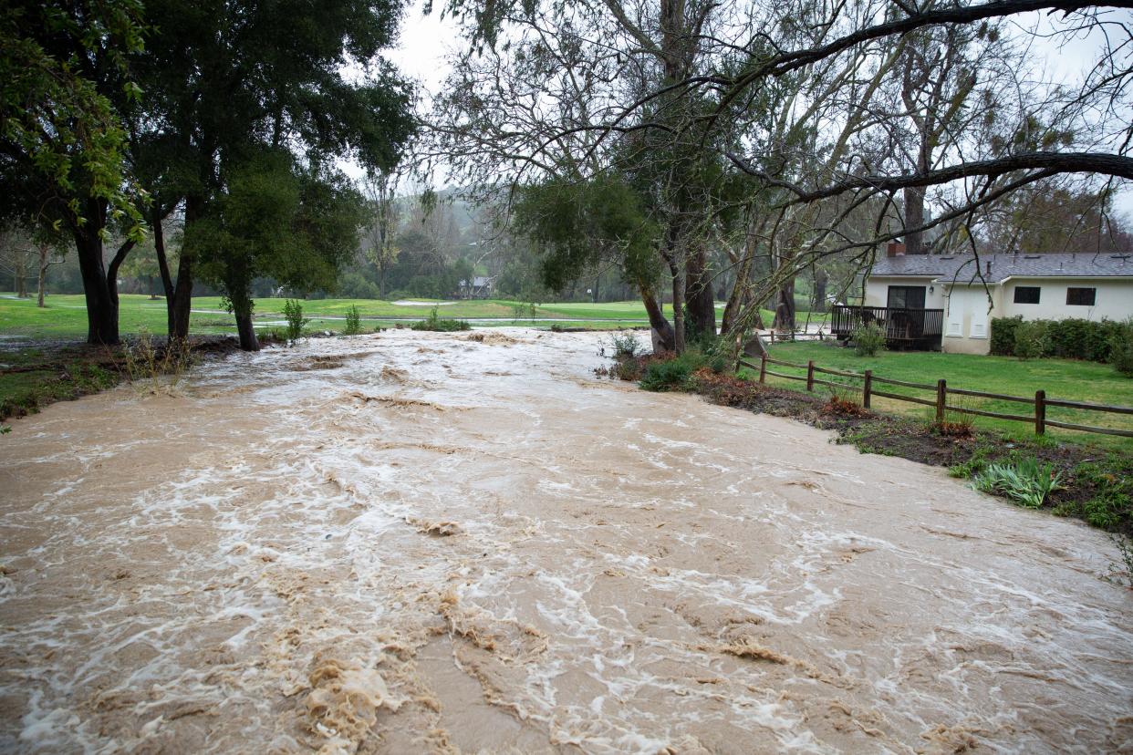 A road flooded with brown water in Santa Barbara County