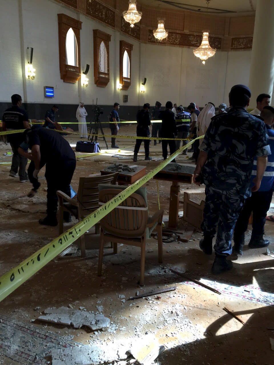 Inspectors work at the Imam Sadiq Mosque after a bomb explosion, in the Al Sawaber area of Kuwait City