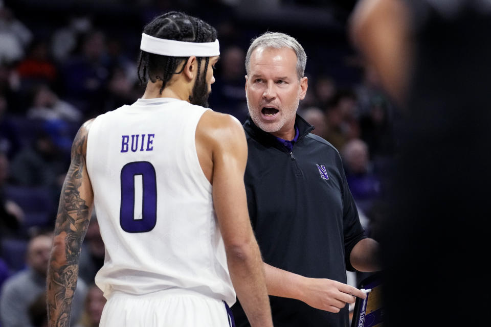 Northwestern head coach Chris Collins, right, talks with guard Boo Buie during the first half of an NCAA college basketball game against Brown in Evanston, Ill., Thursday, Dec. 29, 2022. (AP Photo/Nam Y. Huh)