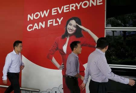 Men walk past an AirAsia sales centre in Kuala Lumpur, Malaysia, June 17, 2015. REUTERS/Olivia Harris