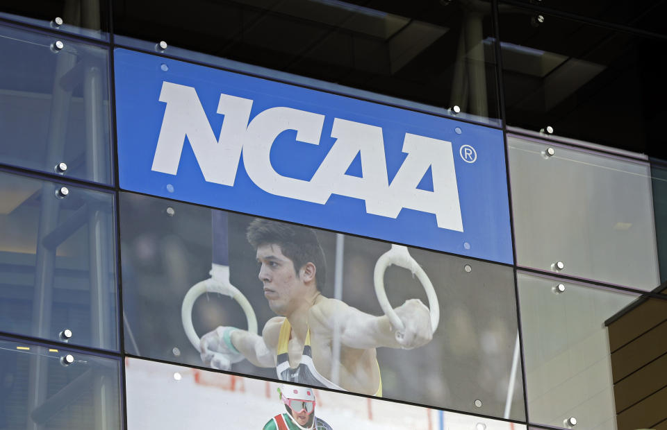 FILE - In this April 25, 2018, file photo, the NCAA headquarters is shown in Indianapolis. The NCAA is expected to approve a recommendation to all athletes who compete in fall sports, including football, over the next 10 months to not be charged a year of eligibility. It's great news for current players, but comes with some complications for teams, coaches and future college football players. (AP Photo/Darron Cummings, File)