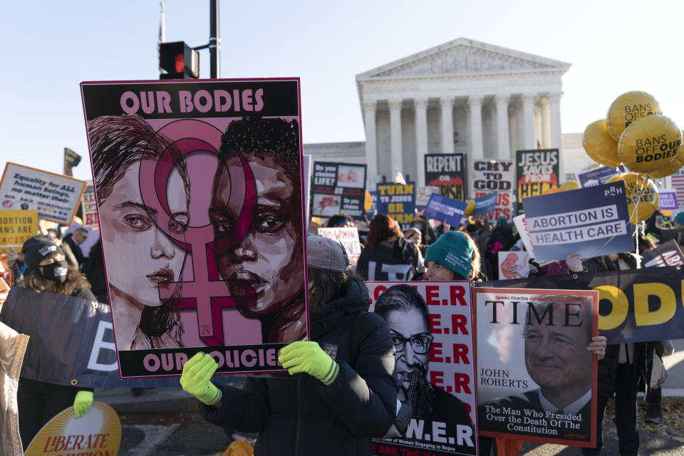 Abortion rights advocates demonstrate in front of the U.S. Supreme Court Wednesday, Dec. 1, 2021, in Washington, as the court hears arguments in a case from Mississippi, where a 2018 law would ban abortions after 15 weeks of pregnancy, well before viability. (AP Photo/Jose Luis Magana)