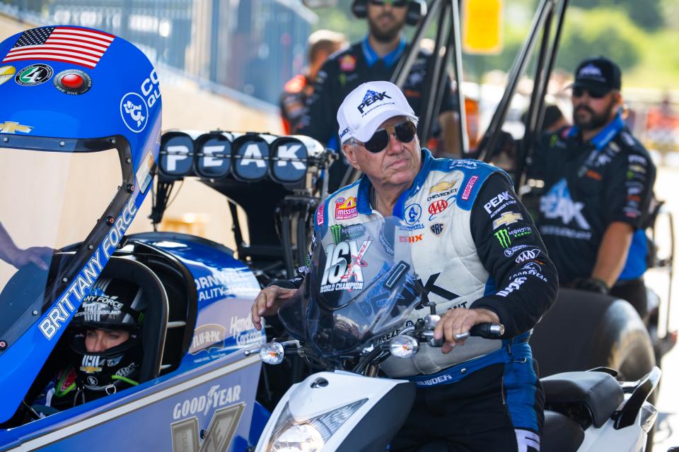 Sixteen-time NHRA Funny Car champion John Force visits with daughter Brittany Force, left, during this year's Route 66 Nationals.