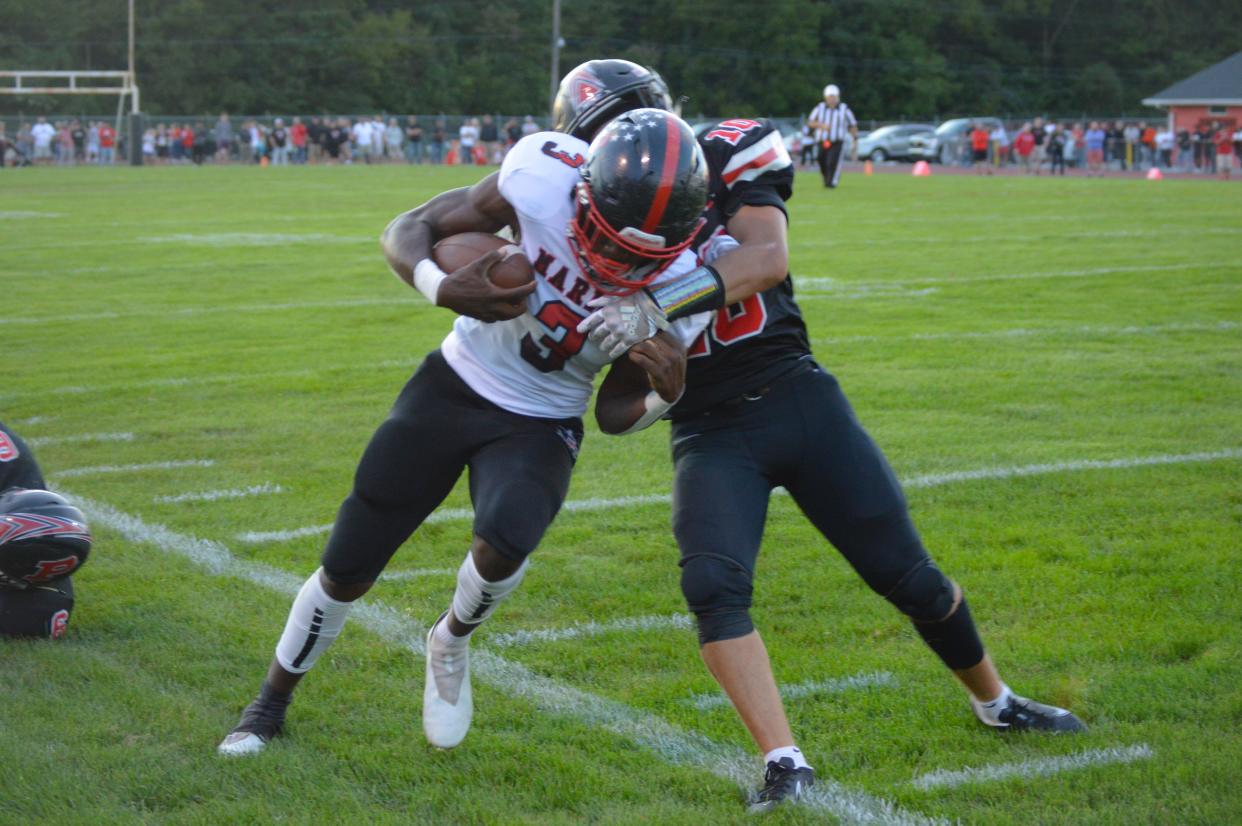 Marion Harding's Trinity Keith runs the football at Pleasant last season.