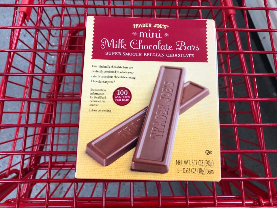 A box of Trader Joe's mini milk-chocolate bars in a red shopping cart.
