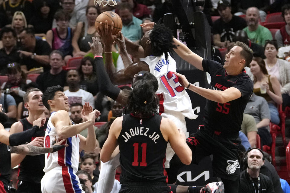 Detroit Pistons center James Wiseman (13) goes to the basket as Miami Heat forward Duncan Robinson, right, defends during the first half of an NBA basketball game Tuesday, March 5, 2024, in Miami. (AP Photo/Lynne Sladky)