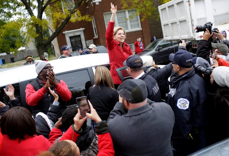 Democratic presidential candidate Senator Elizabeth Warren waves as she visits a picket line of striking teachers in Chicago