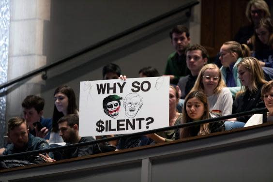 Protesters hold up a sign comparing Donald Trump to The Joker during a talk by former national security adviser at Duke University in North Carolina (AFP via Getty Images)