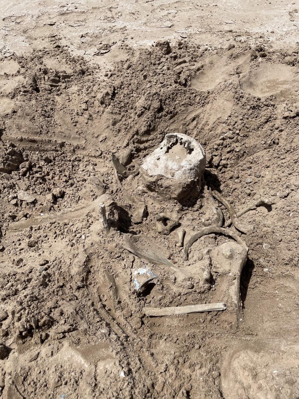 This photo of Saturday, May 7, 2022, provided by Lindsey Melvin of Henderson, Nev., shows human remains she and her sister discovered on a sandbar that recently surfaced as Lake Mead recedes. A closer look revealed a human jaw with teeth. The National Park Service confirmed in a statement that the remains are human. (Lindsey Melvin via AP)