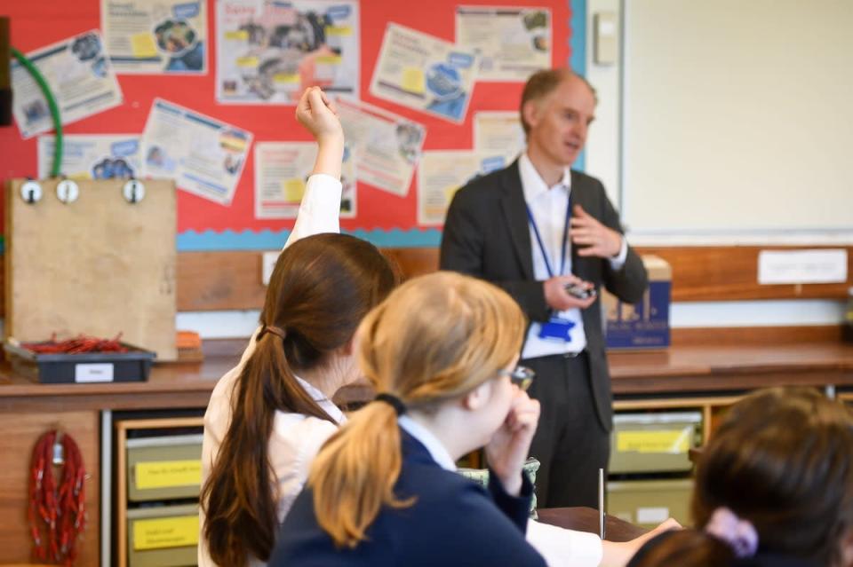 A teacher talks with students in a science class at Royal High School Bath. (Ben Birchall/PA) (PA Archive)