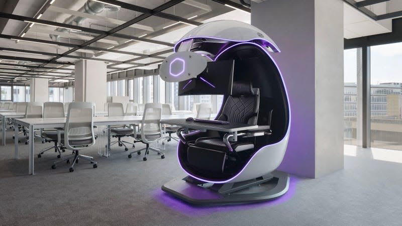 The Cooler Master Orb X shown sitting in a large office space full of tables and chairs.