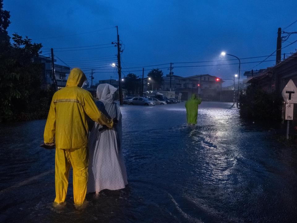 Residents walk in the flooded street in Chiayi, Taiwan (Getty Images)