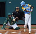 Honolulu, Hawaii's Mana Lau Kong, right, hits the first pitch of the baseball game from South Korea's Yeong Hyeon Kim for a solo home run in the first inning of the Little League World Series Championship in South Williamsport, Pa., Sunday, Aug. 26, 2018. (AP Photo/Tom E. Puskar).