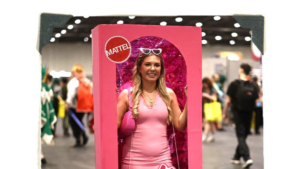 woman dressed as barbie in a box