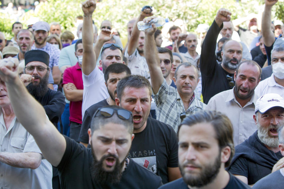 Opponents of the march shout as they block off the capital's main avenue to an LGBT march in Tbilisi, Georgia, Monday, July 5, 2021. A protest against a planned LGBT march in the Georgian capital turned violent on Monday as demonstrators attacked journalists. Organizers of the Tbilisi March For Dignity that was to take place in the evening cancelled the event, saying authorities had not provided adequate security guarantees. (AP Photo/Shakh Aivazov)