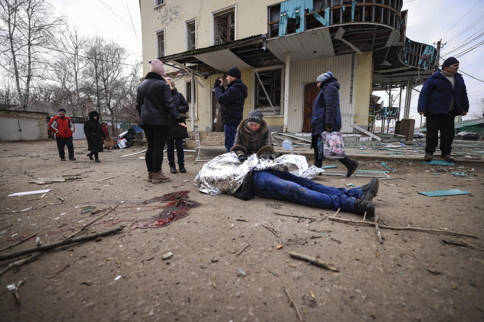 Nina Kovalenko, 66, cries over the body of her son Mykhailo Kovalenko, 34, who was killed by a Russian attack in Kostiantynivka, Ukraine, Saturday, Jan. 28, 2023. (AP Photo/Andriy Dubchak)