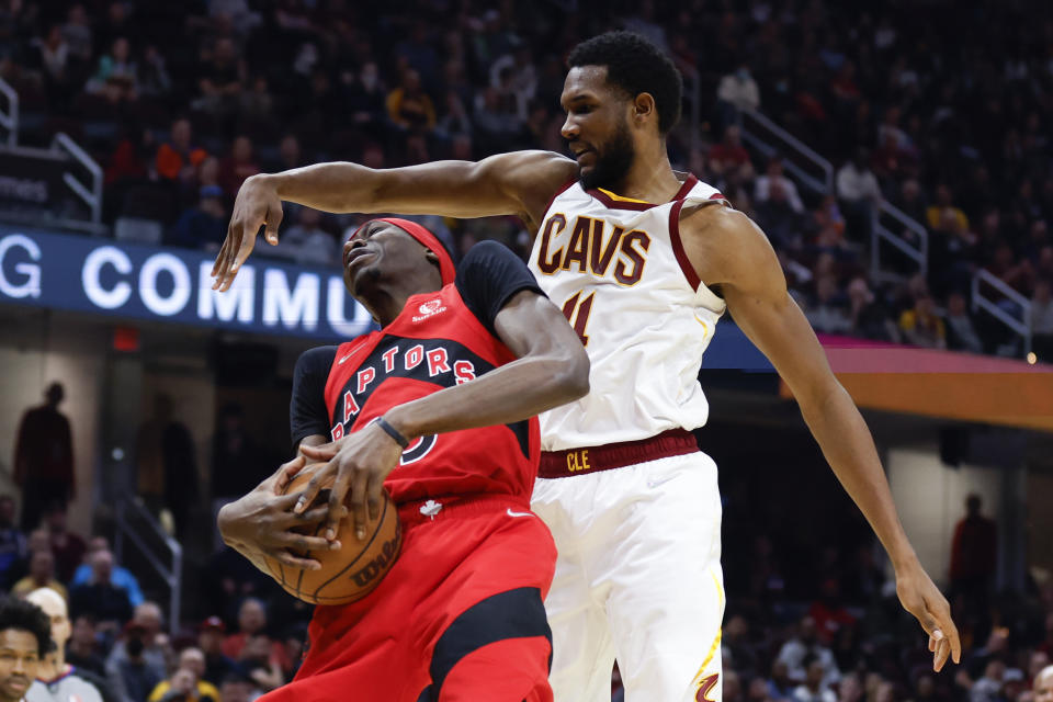 Toronto Raptors' Chris Boucher (25) grabs a rebound against Cleveland Cavaliers' Evan Mobley (4) during the first half of an NBA basketball game, Sunday, March 6, 2022, in Cleveland. (AP Photo/Ron Schwane)