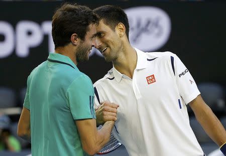 Serbia's Novak Djokovic (R) and France's Gilles Simon laugh as they shake hands at the net after Djokovic won their fourth round match at the Australian Open tennis tournament at Melbourne Park, Australia, January 24, 2016. REUTERS/Issei Kato