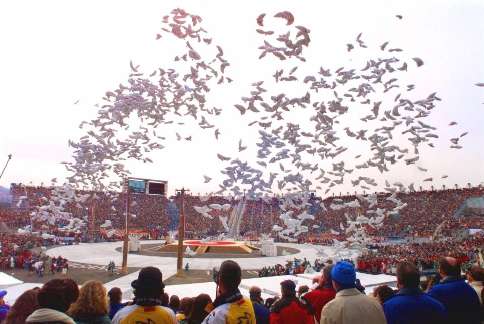 Balloons in the shape of doves fly past spectators at the conclusion of the opening ceremony of the Winter Olympics in Nagano, Japan, Saturday, Feb. 7, 1998.