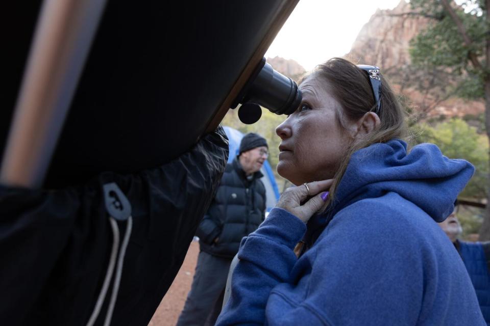 Christie Swords of Las Vegas peers at the moon through a 17.5-inch telescope