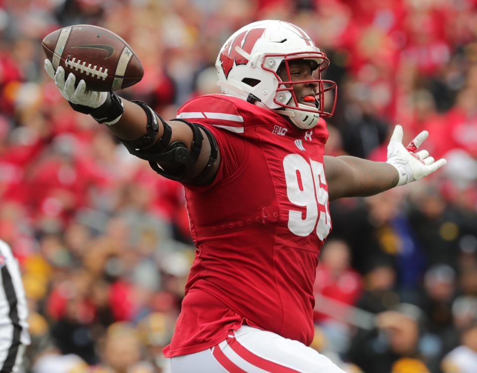 Wisconsin nose tackle Keeanu Benton (95) recovers a fumble by Iowa quarterback Spencer Petras during the second quarter.