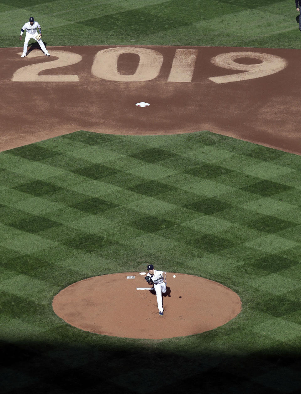 Seattle Mariners starting pitcher Marco Gonzales throws the first pitch of the team's home-opener against the Boston Red Sox as shortstop Tim Beckham stands near second during the first inning of a baseball game Thursday, March 28, 2019, in Seattle. (AP Photo/Elaine Thompson)