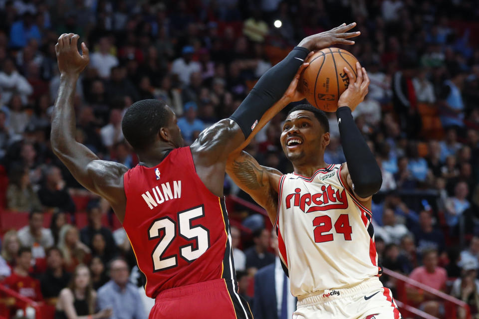 Portland Trail Blazers guard Kent Bazemore (24) goes up to shoot against Miami Heat guard Kendrick Nunn (25) during the first half of an NBA basketball game, Sunday, Jan. 5, 2020, in Miami. (AP Photo/Wilfredo Lee)