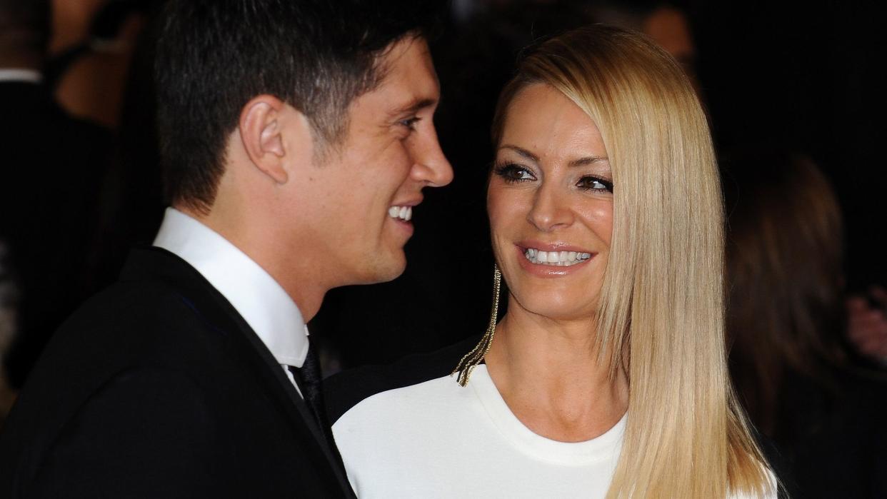Vernon Kay in a suit with Tess Daly in a white dress